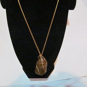Gold tone chain wrap around polished tigers eye stone